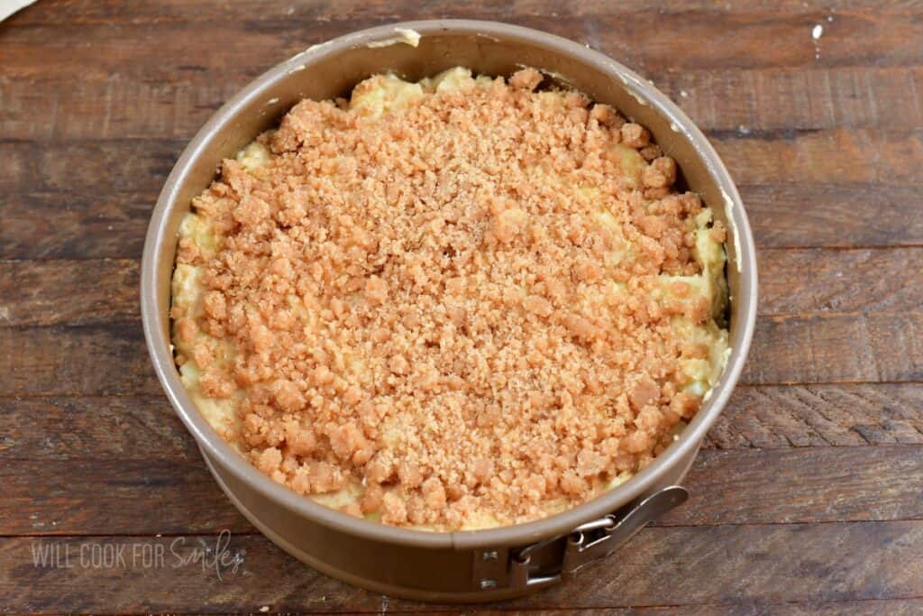 unbaked cake batter topped with streusel in the pan.