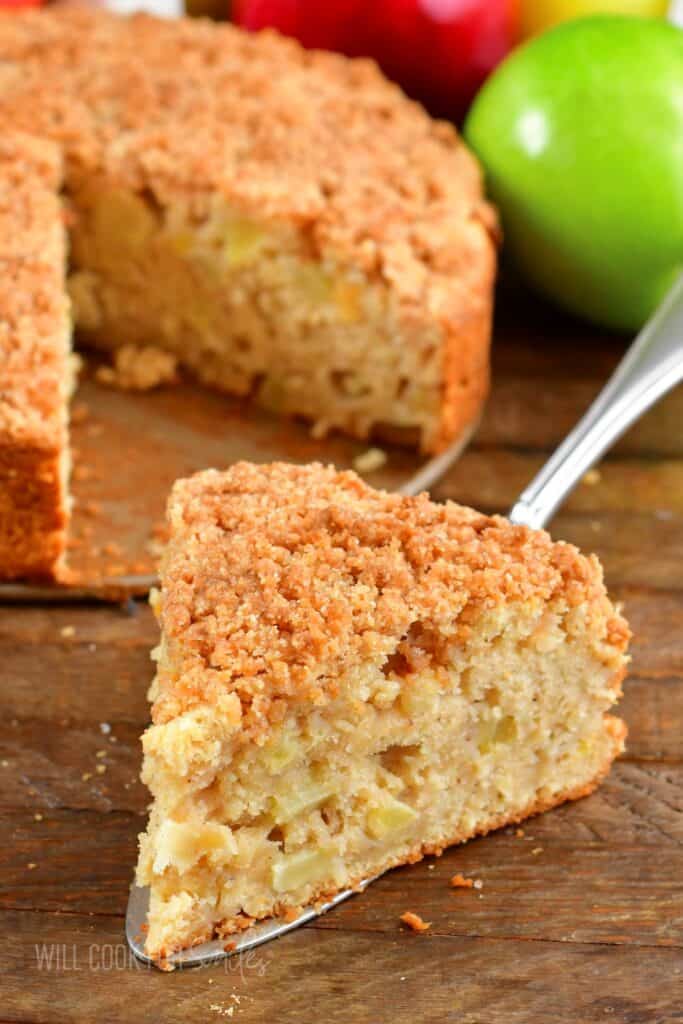 closeup of a slice of apple cake with streusel topping.