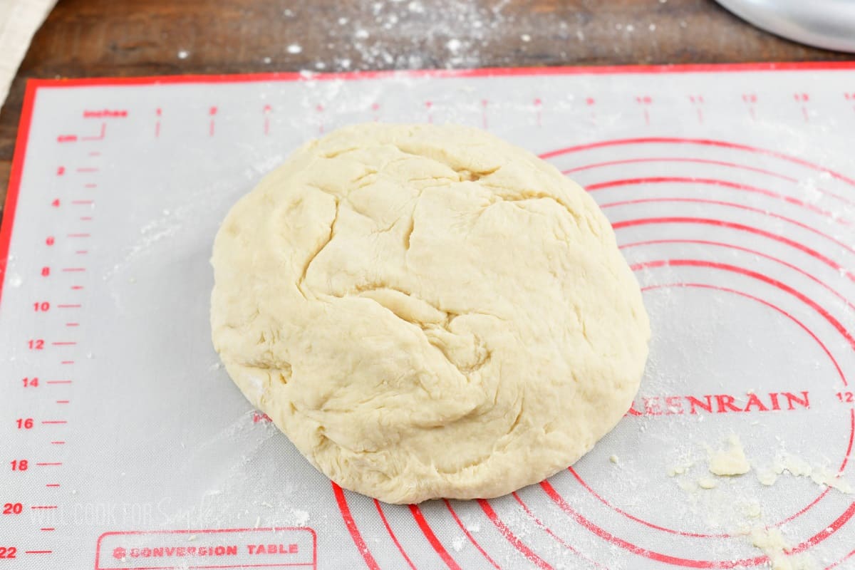 kneaded dough on the white and red silicone mat.