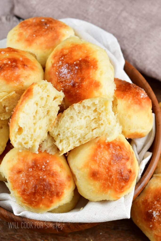 top view of several potato rolls and one broken apart.