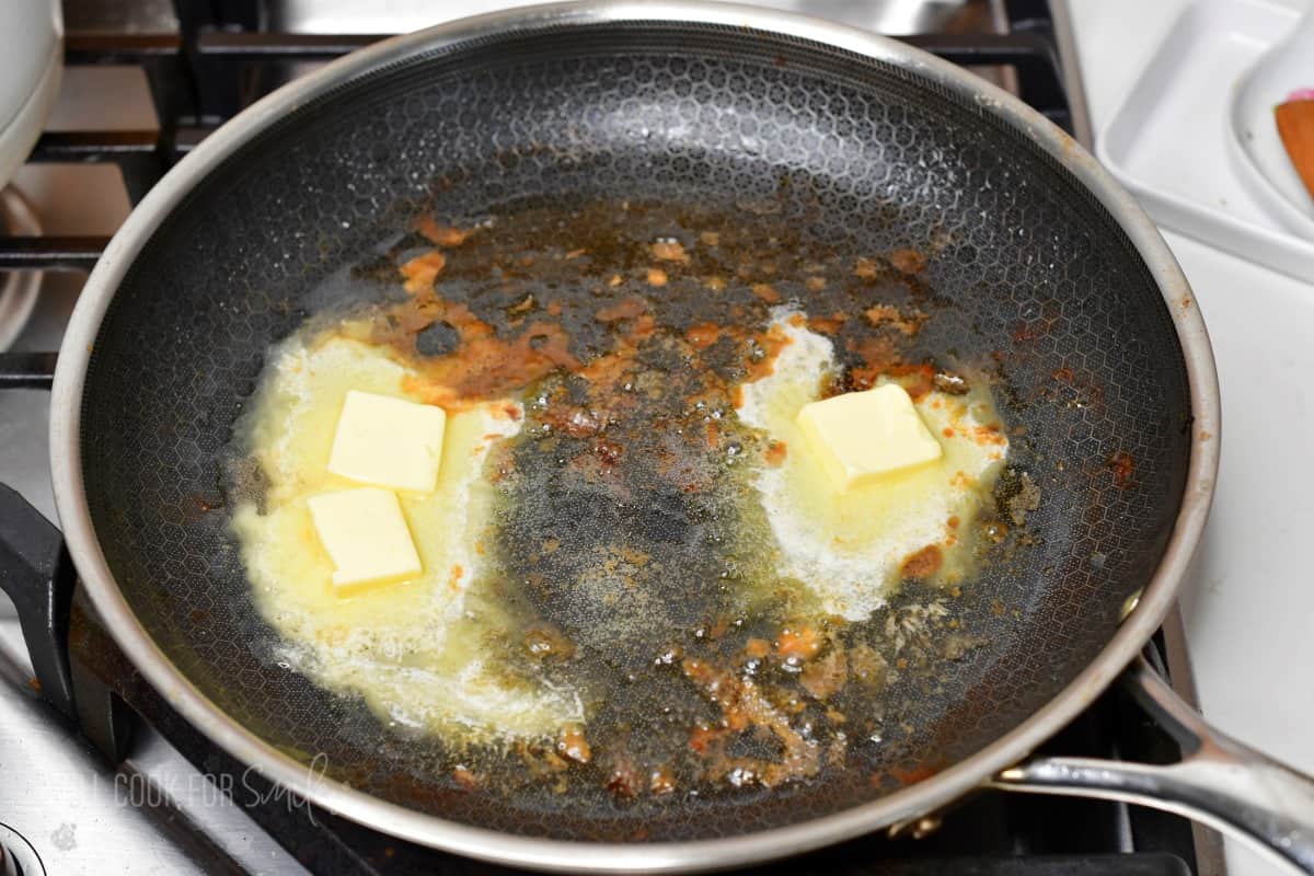 pieces of butter melting in the pan.