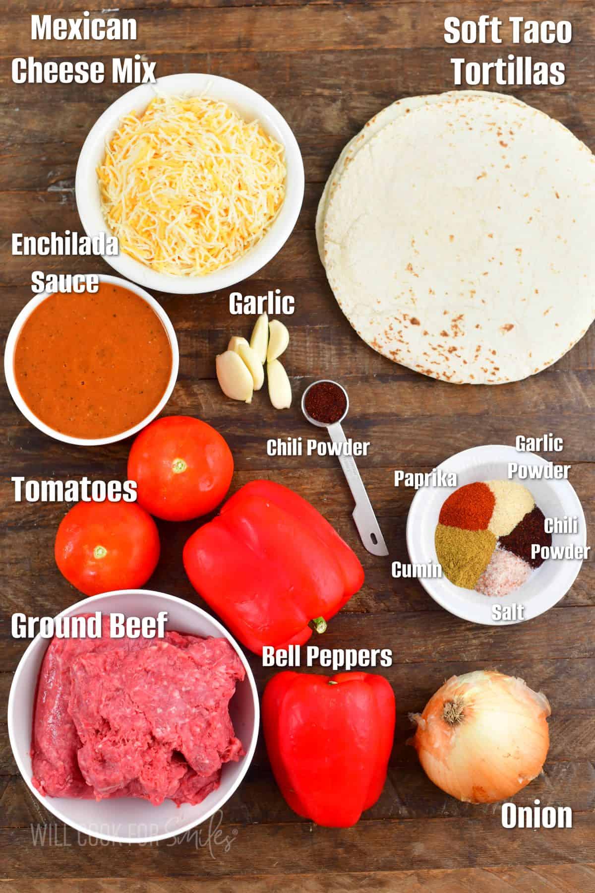 labeled ingredients for the beef enchiladas on a wooden board.