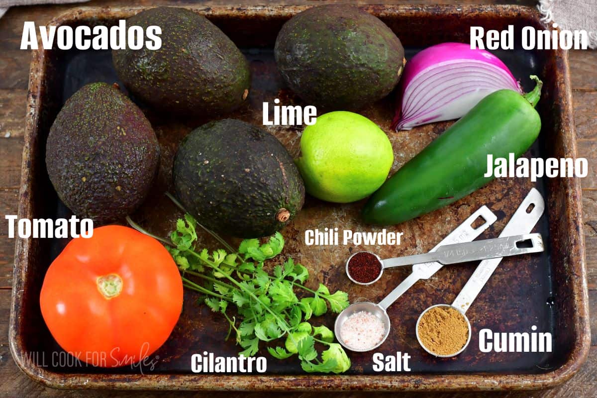ingredients to make guacamole on a sheet tray labaled.
