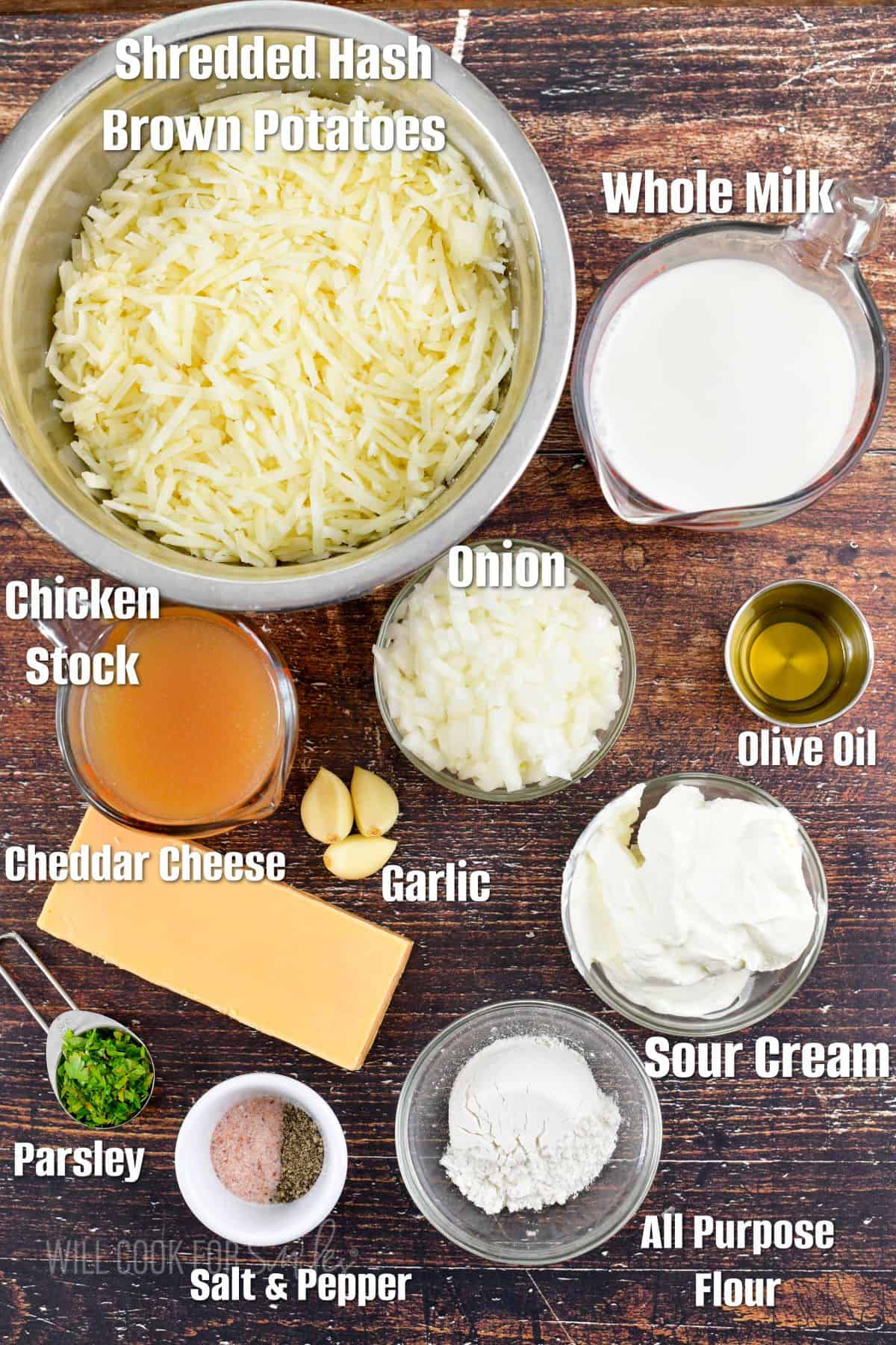 labeled ingredients for hashbrown casserole on wooden background.
