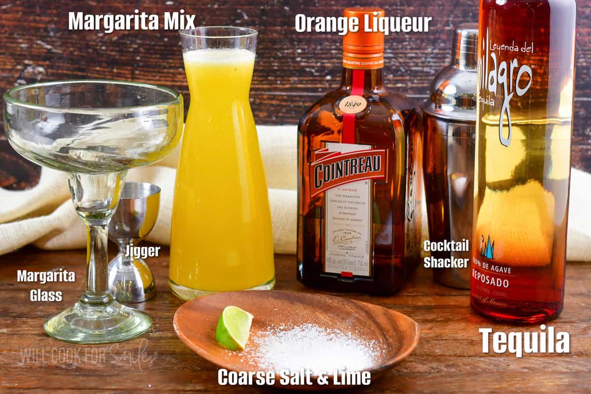 ingredients for a classic margarita on a wooden board and labeled.