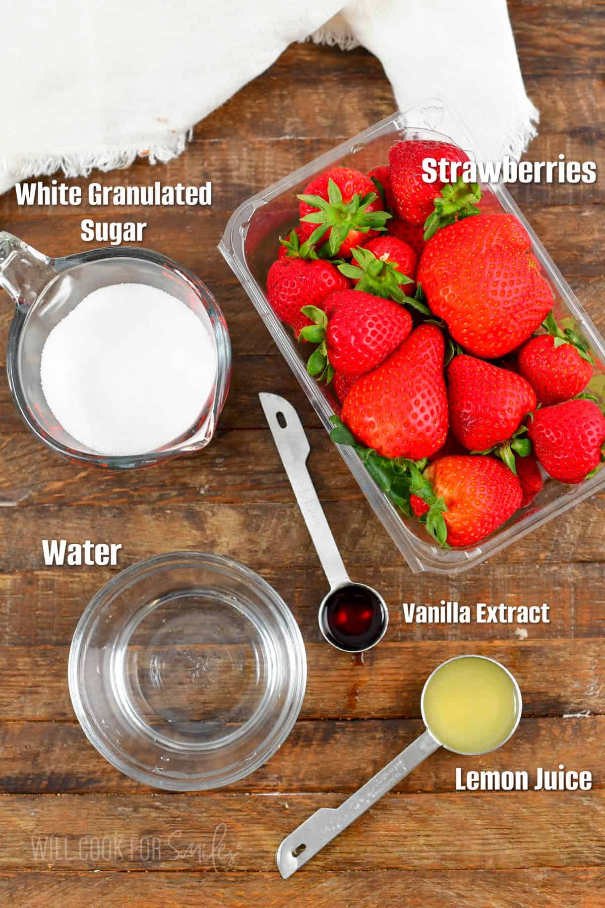 labeled ingredients for strawberry topping on a wooden board.