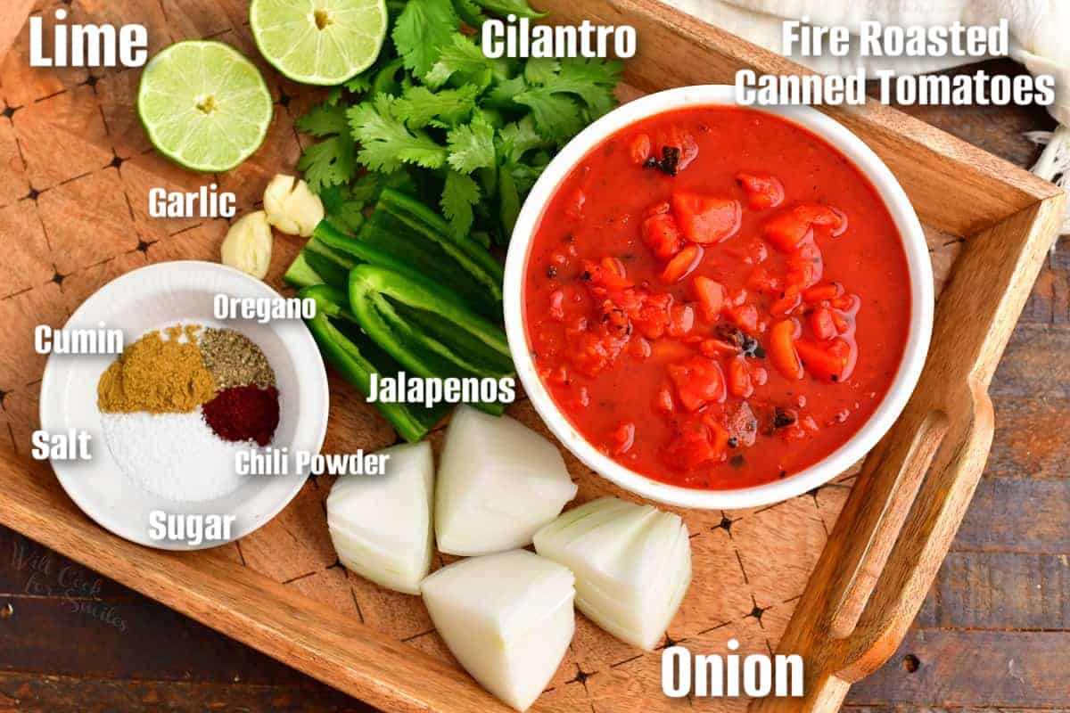 labeled ingredients to make restaurant style salsa on a wooden tray.