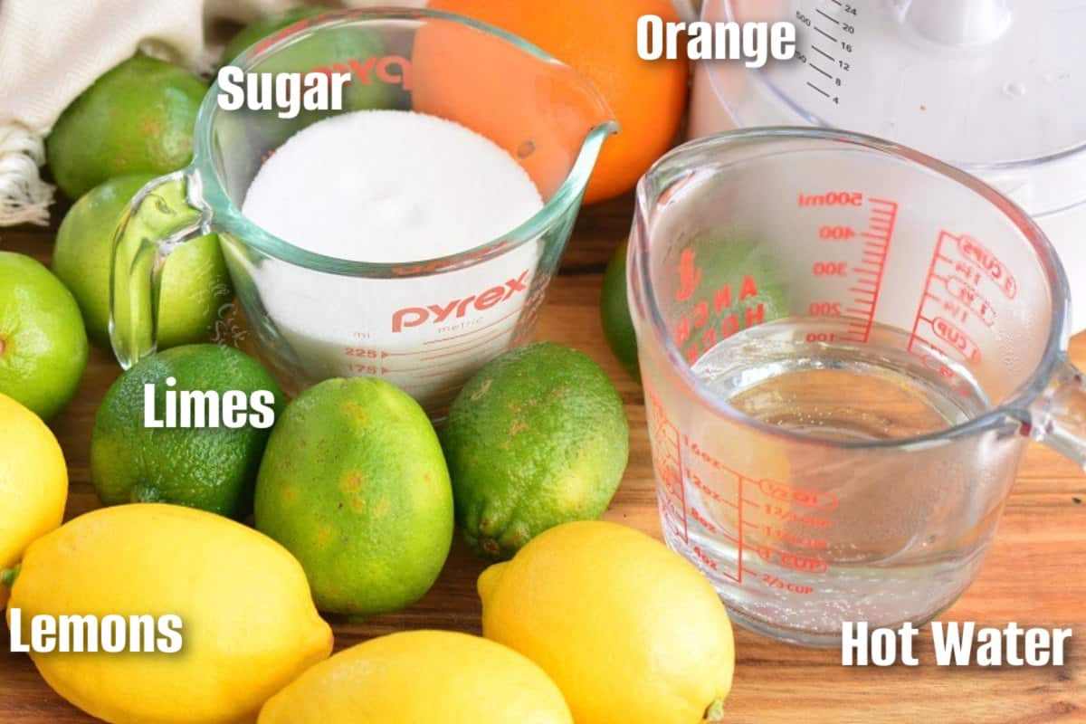 ingredients to make a margarita mix on a cutting board with labels.