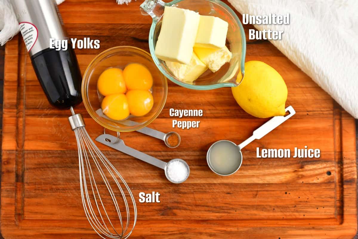 labeled ingredients for hollandaise sauce on a cutting board.