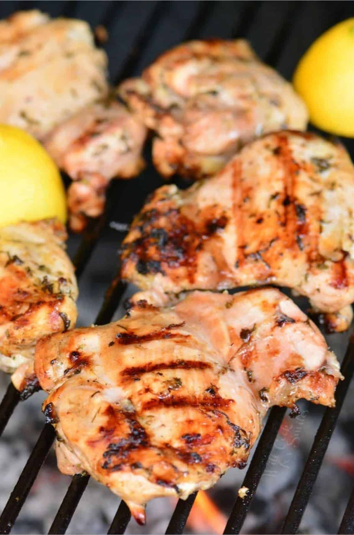 Greek marinated cooking chicken thighs on the grill.