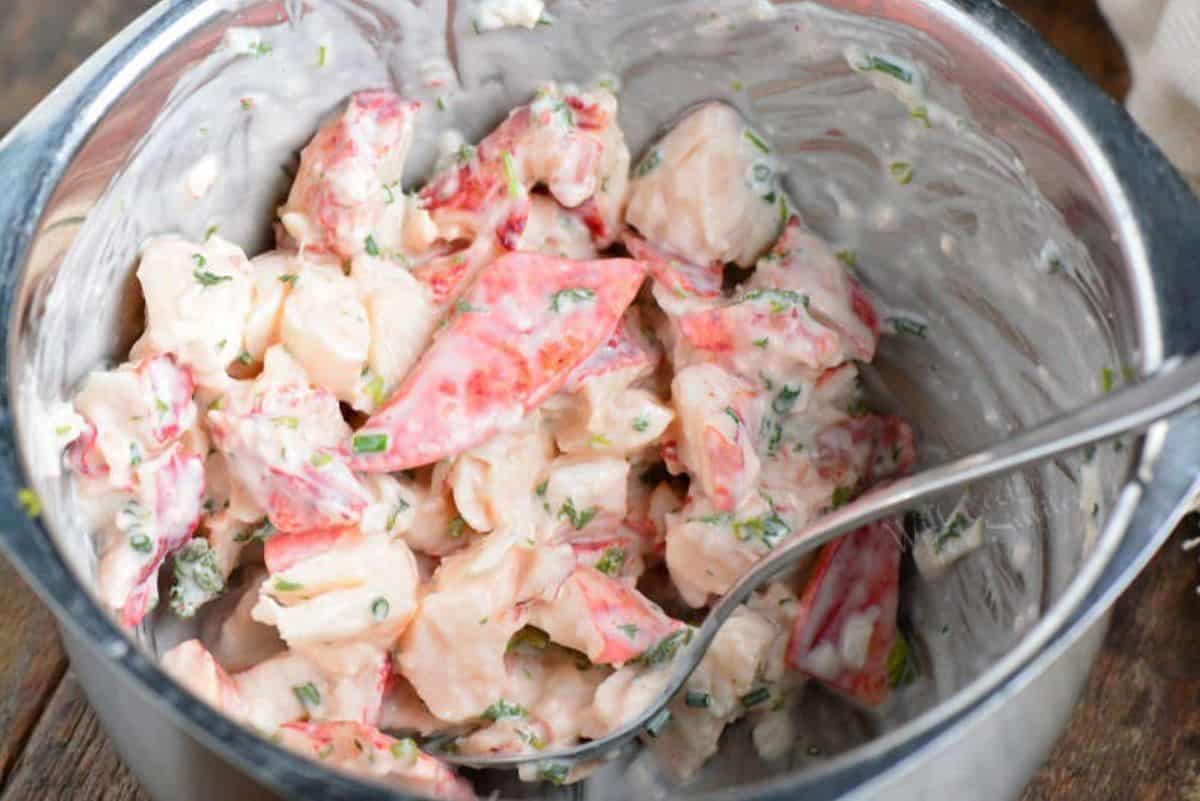 mixing lobster meat for the rolls in the mixing bowl.