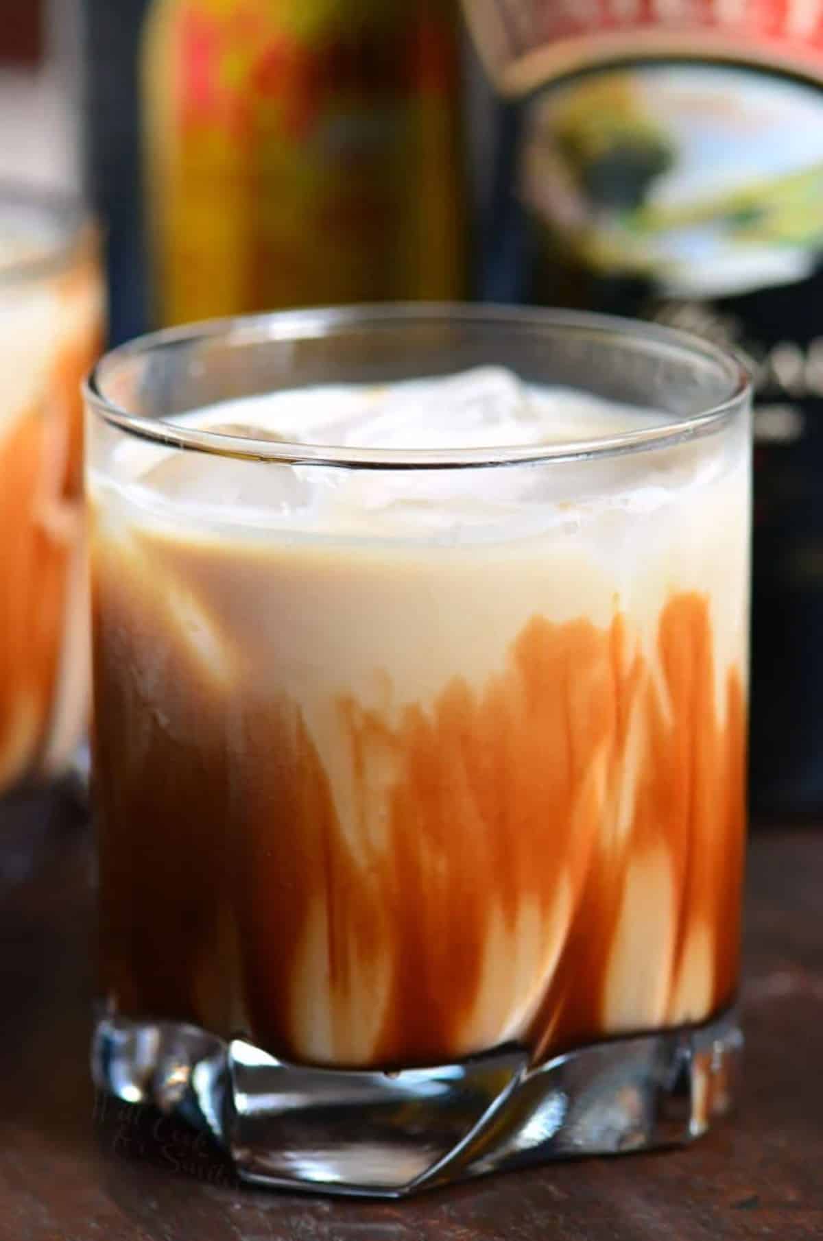 creamy mud slide cocktail in a short glass with chocolate down inside the glass.