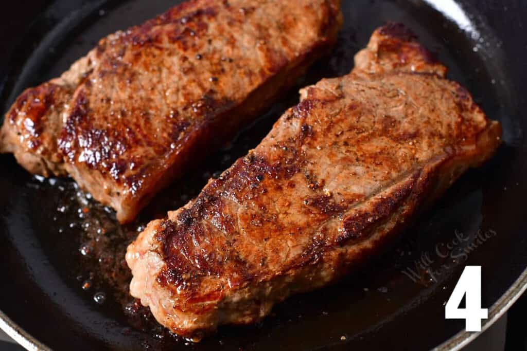 two seared steaks in the cast iron skillet.