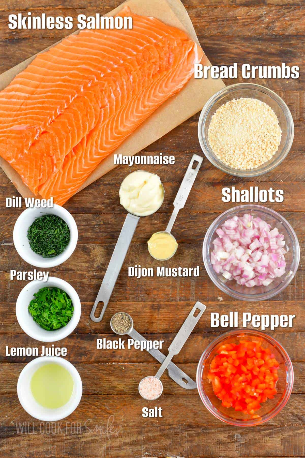 labeled ingredients for salmon patties on wooden board.