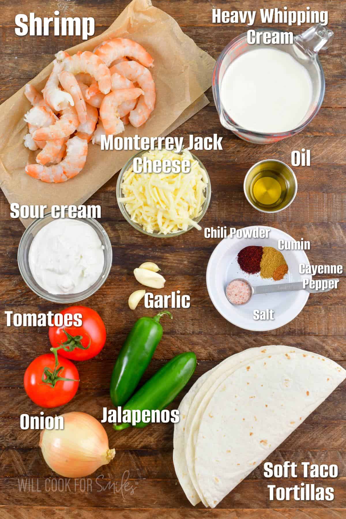 labeled ingredients for shrimp enchiladas on wooden board.