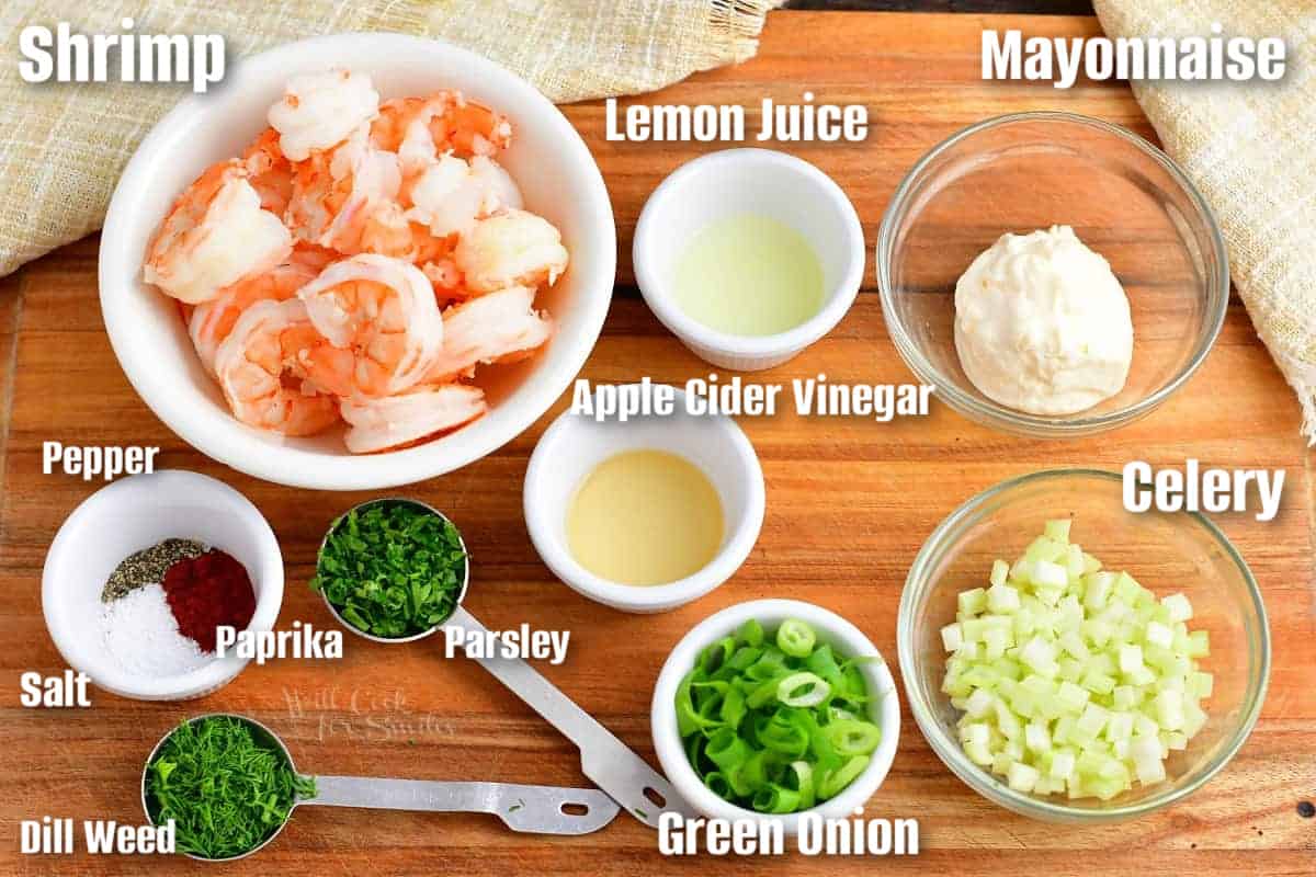 labeled ingredients to make shrimp salad for the rolls on the cutting board.