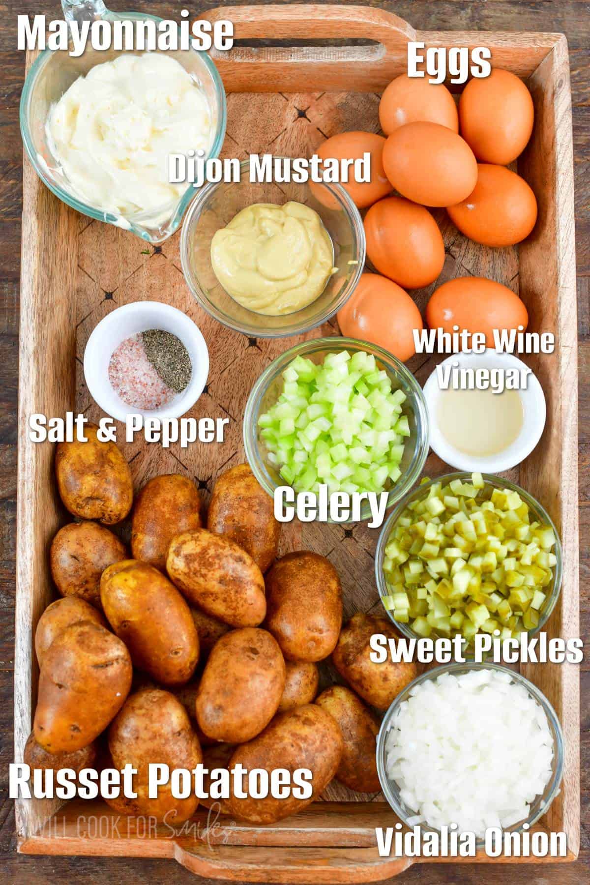 labeled ingredients for southern potato salad on a wooden tray.