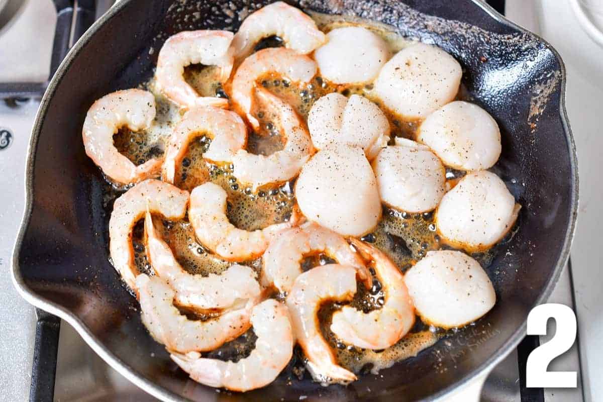 scallops and shrimp cooking in the skillet.