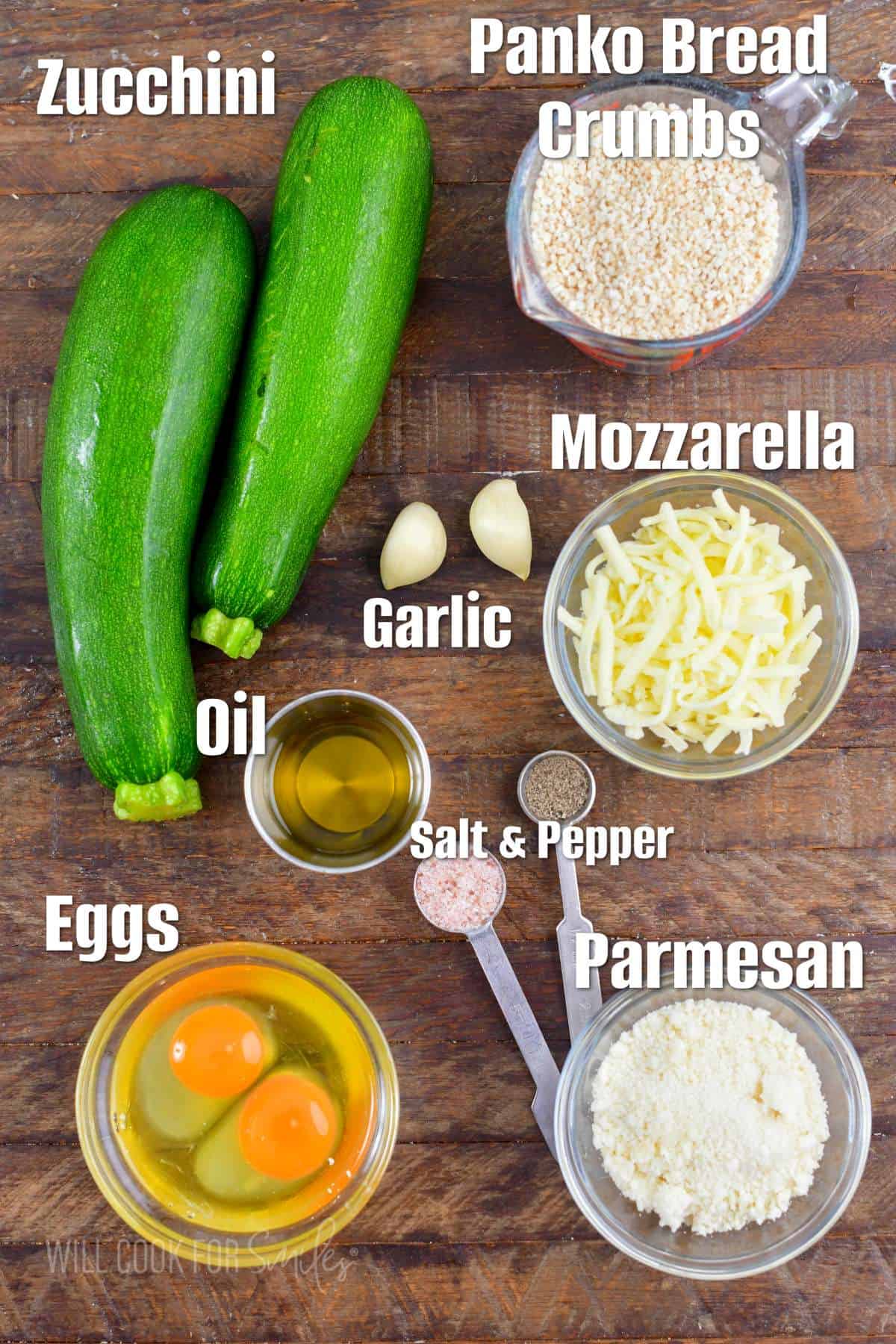 labeled ingredients for making zucchini fritters on the wooden board.