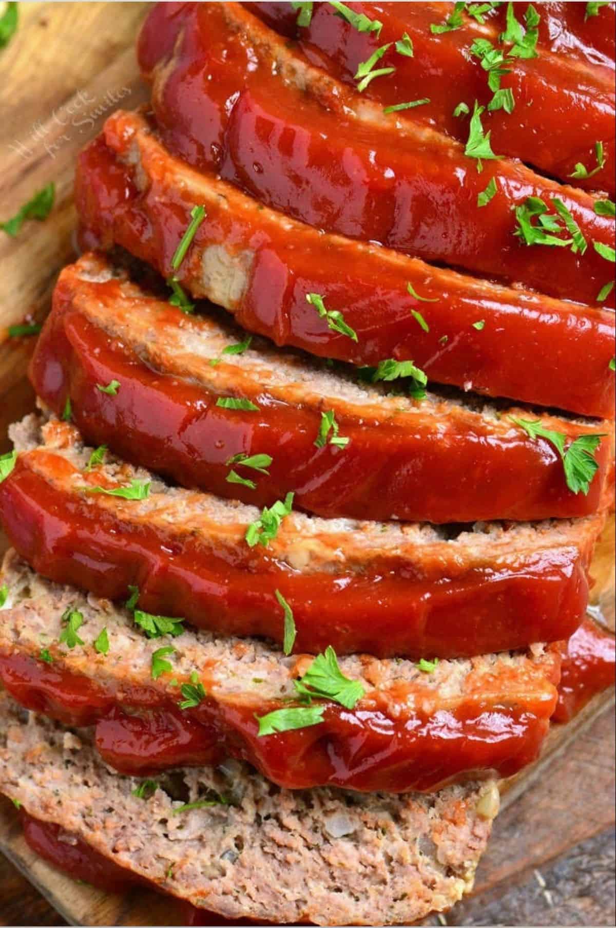 several slices of meatloaf side by site topped with ketchup topping.