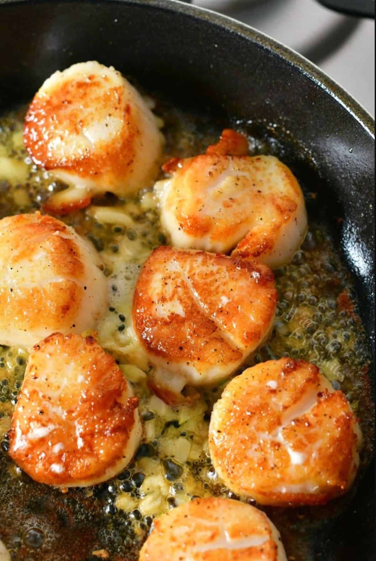 searing scallops in a skillet in butter and minced garlic.