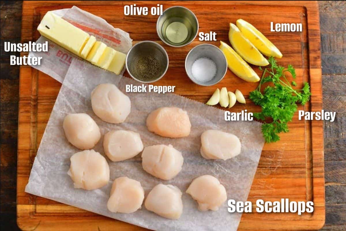labeled ingredients to make seared scallops on the cutting board.