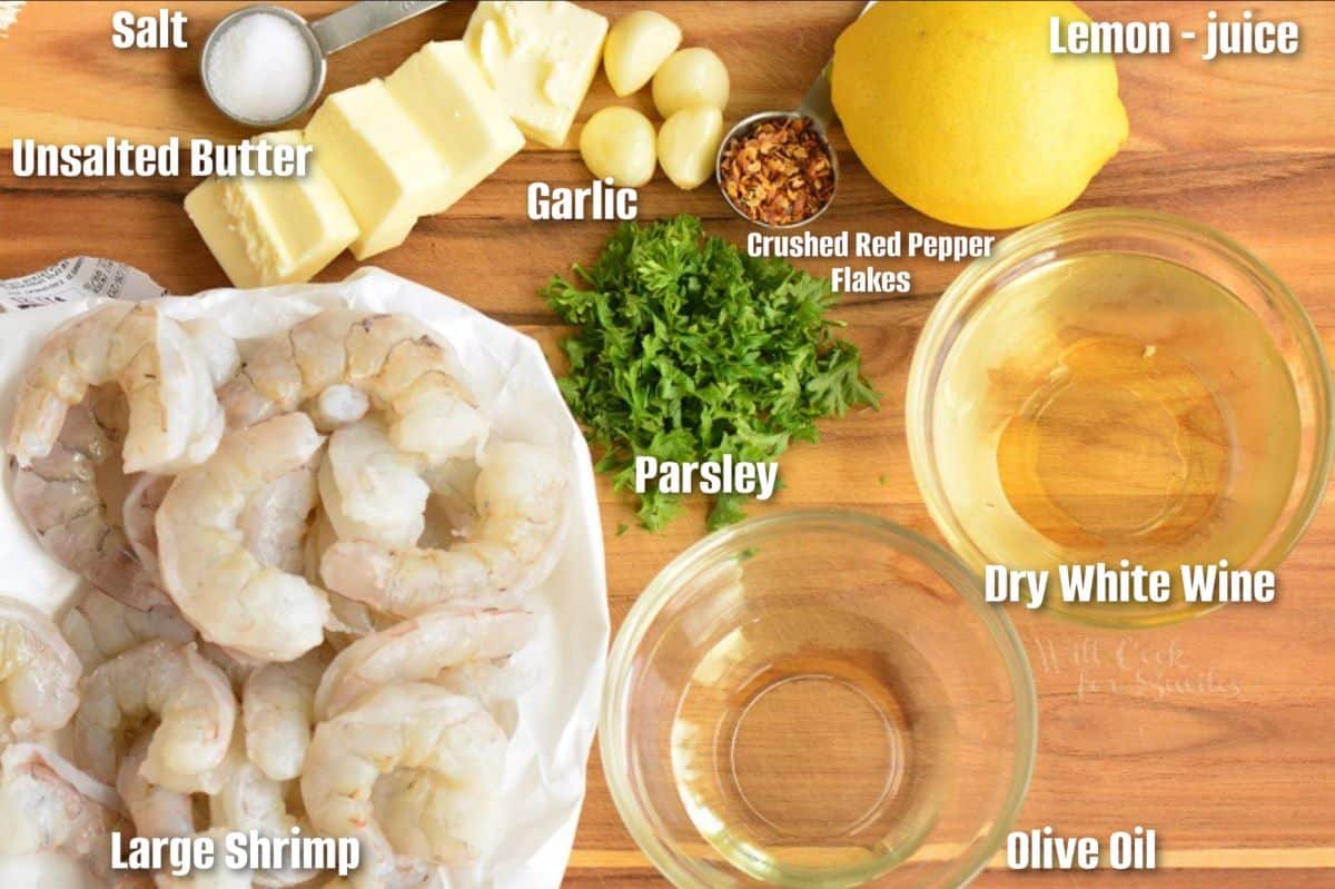 Labeled ingredients for shrimp scampi are placed on a wooden surface.