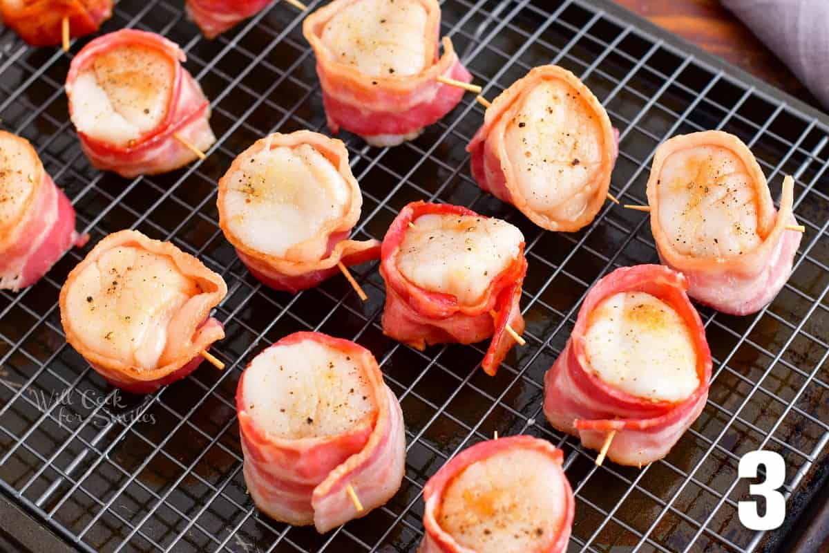 scallops wrapped in bacon on the baking rack before baking.