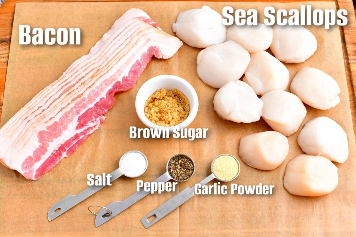 labeled ingredients to make bacon wrapped scallops on parchment paper.