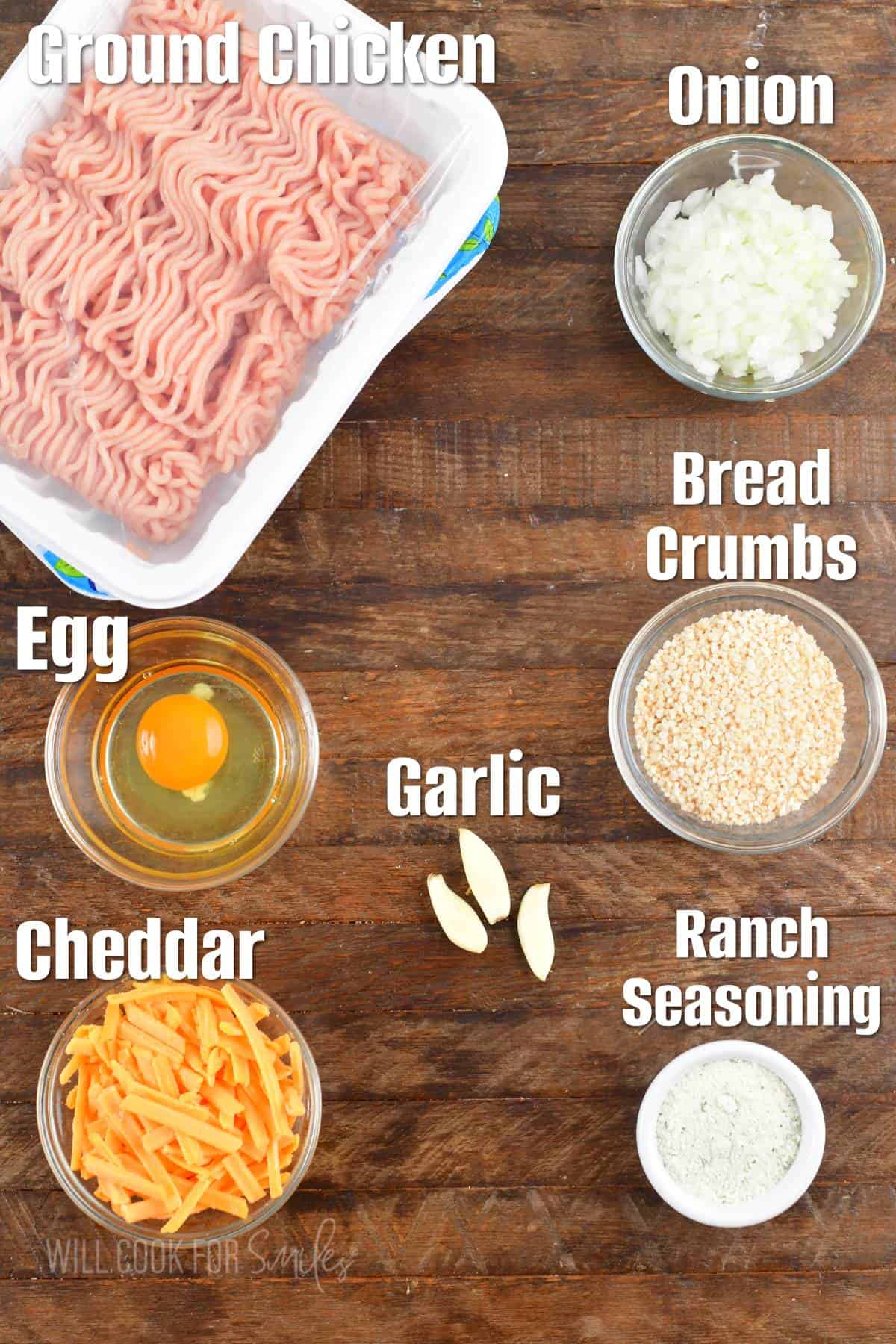 Labeled ingredients to make cheddar ranch chicken burgers on a board.