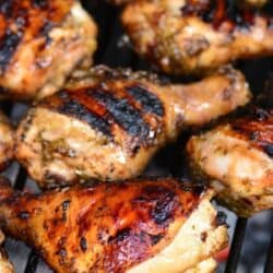 marinated chicken drumstick cooking on the grill.