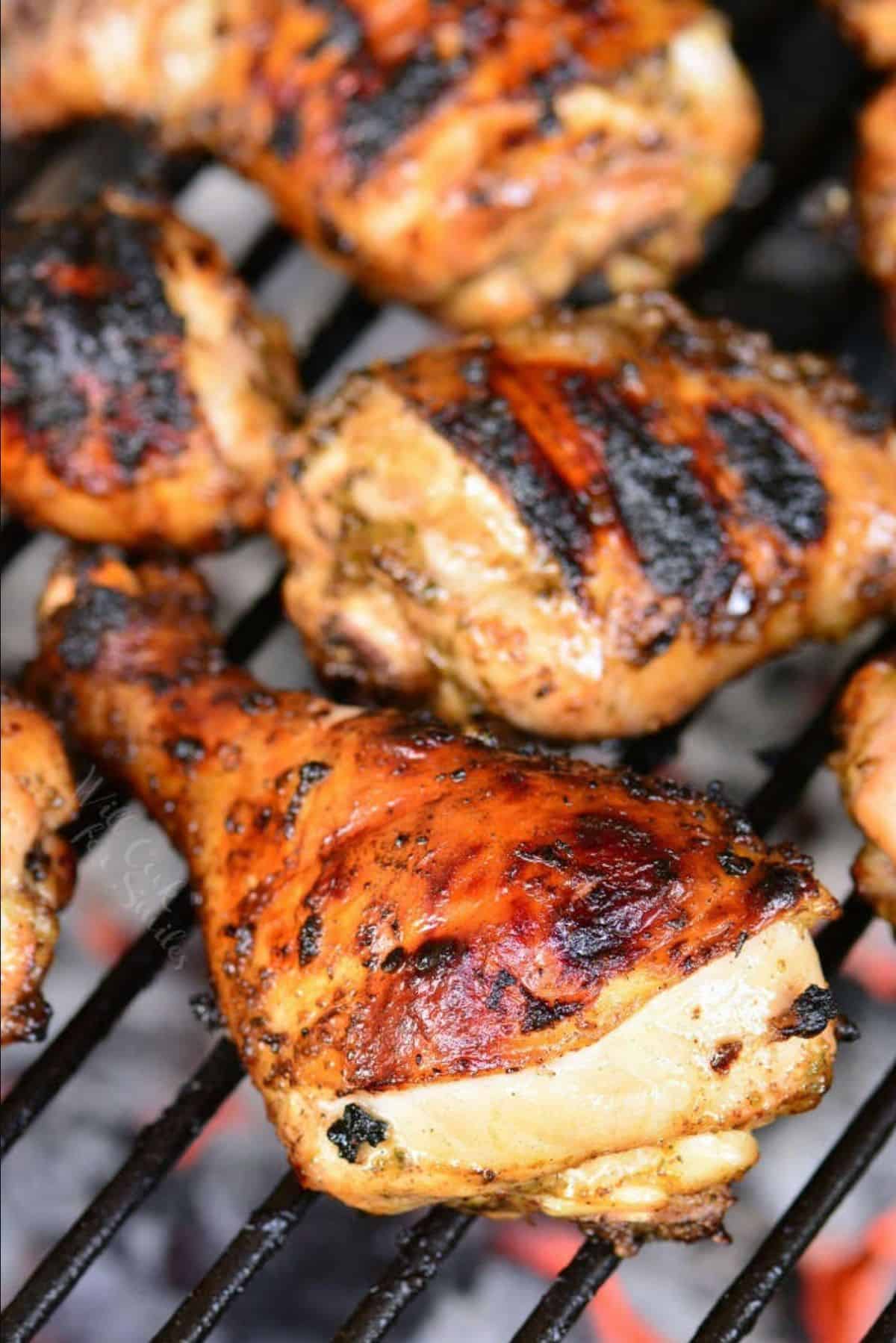jerk marinated chicken drumstick cooking on the grill.