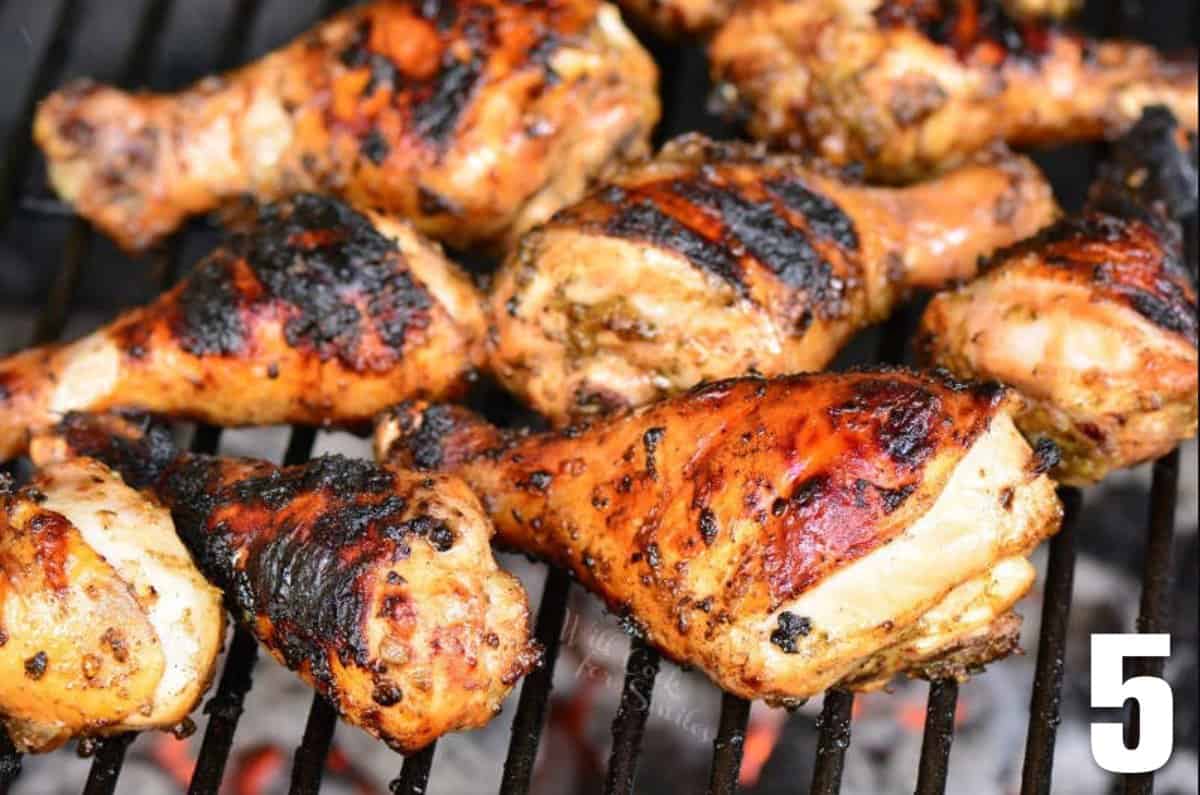 jerk marinated chicken drumsticks cooking on the charcoal grill.