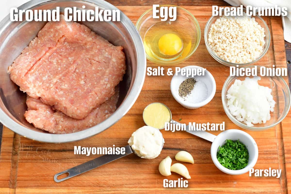 labeled ingredients to make chicken burgers on a cutting board.