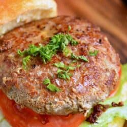 turkey burger on a bun with lettuce and tomato.