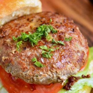 turkey burger on a bun with lettuce and tomato.