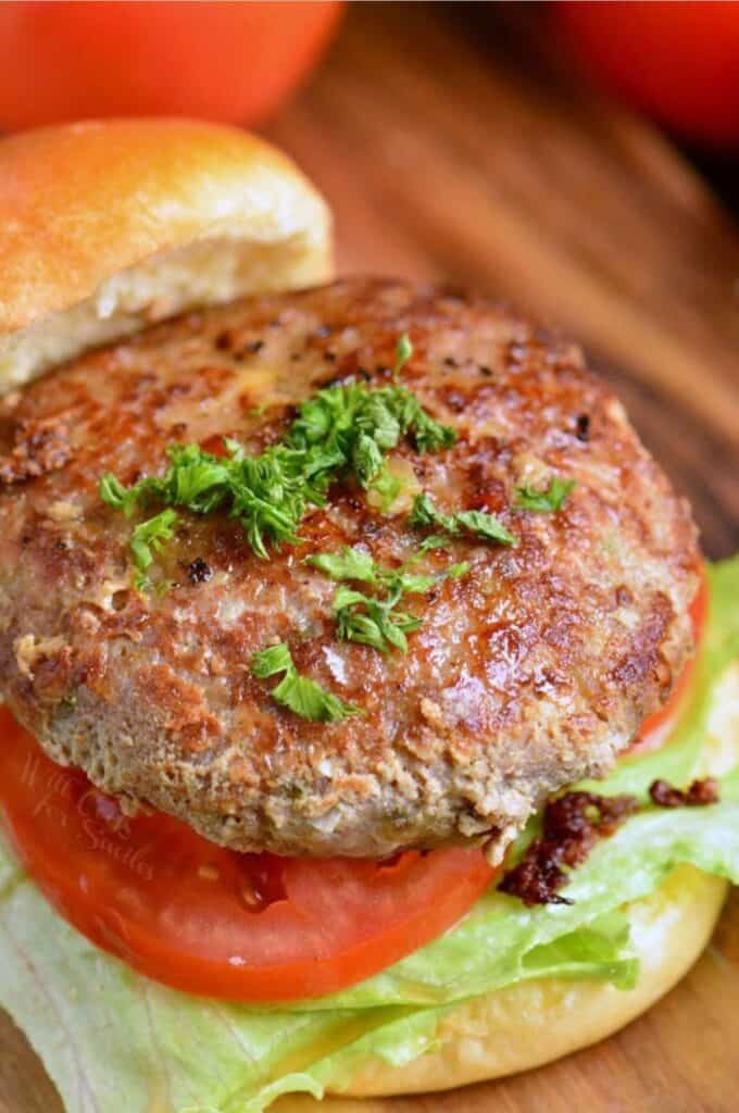 turkey burger on a bun with lettuce and tomato.