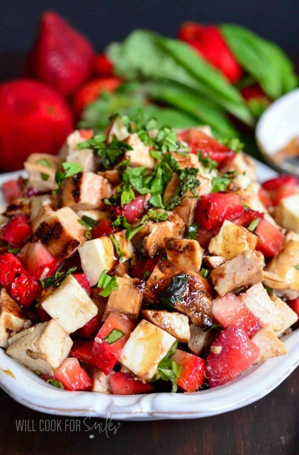 Parsley garnishes a balsamic strawberry chicken salad. 