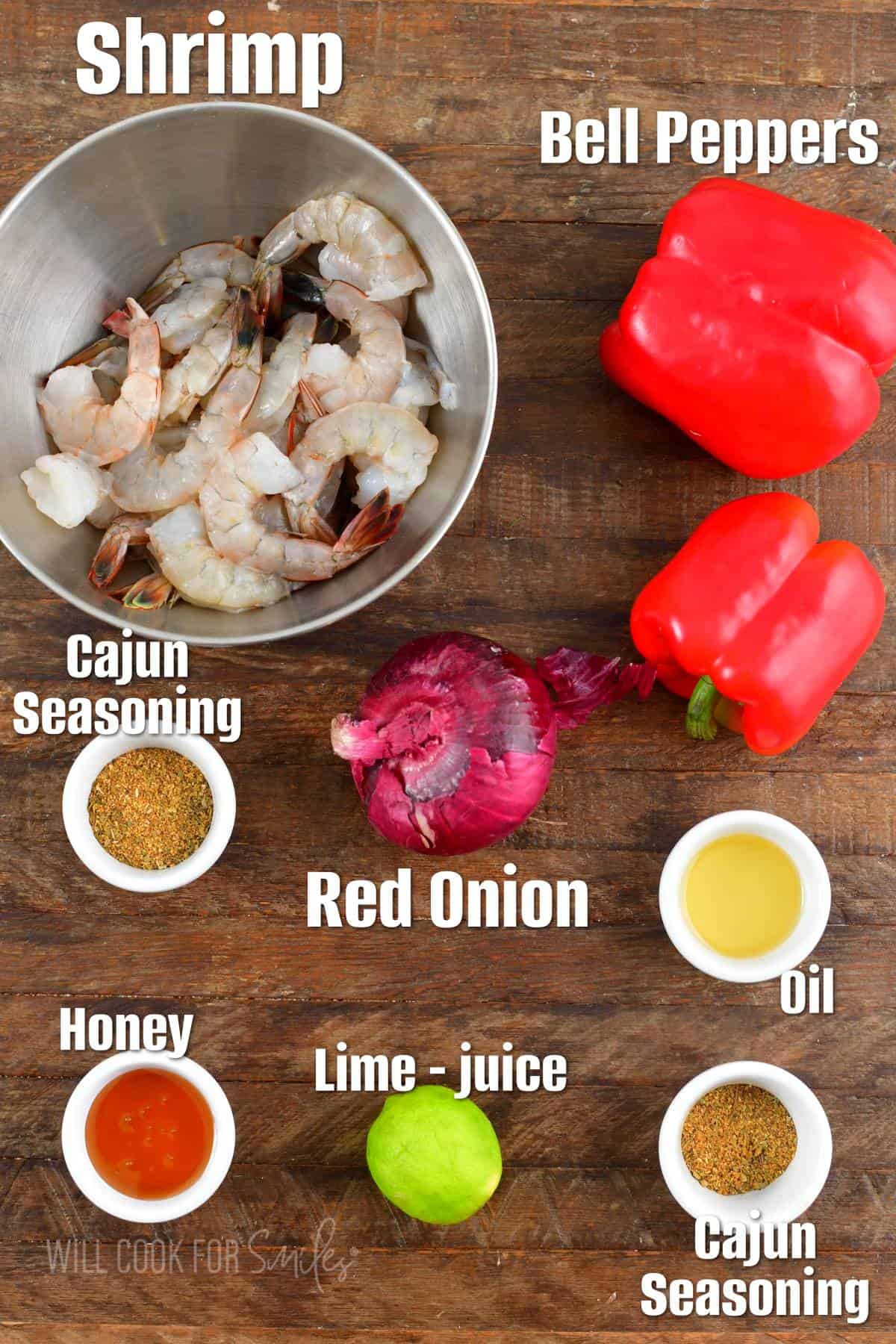 the ingredients for cajun grilled shrimp are placed on a wooden surface