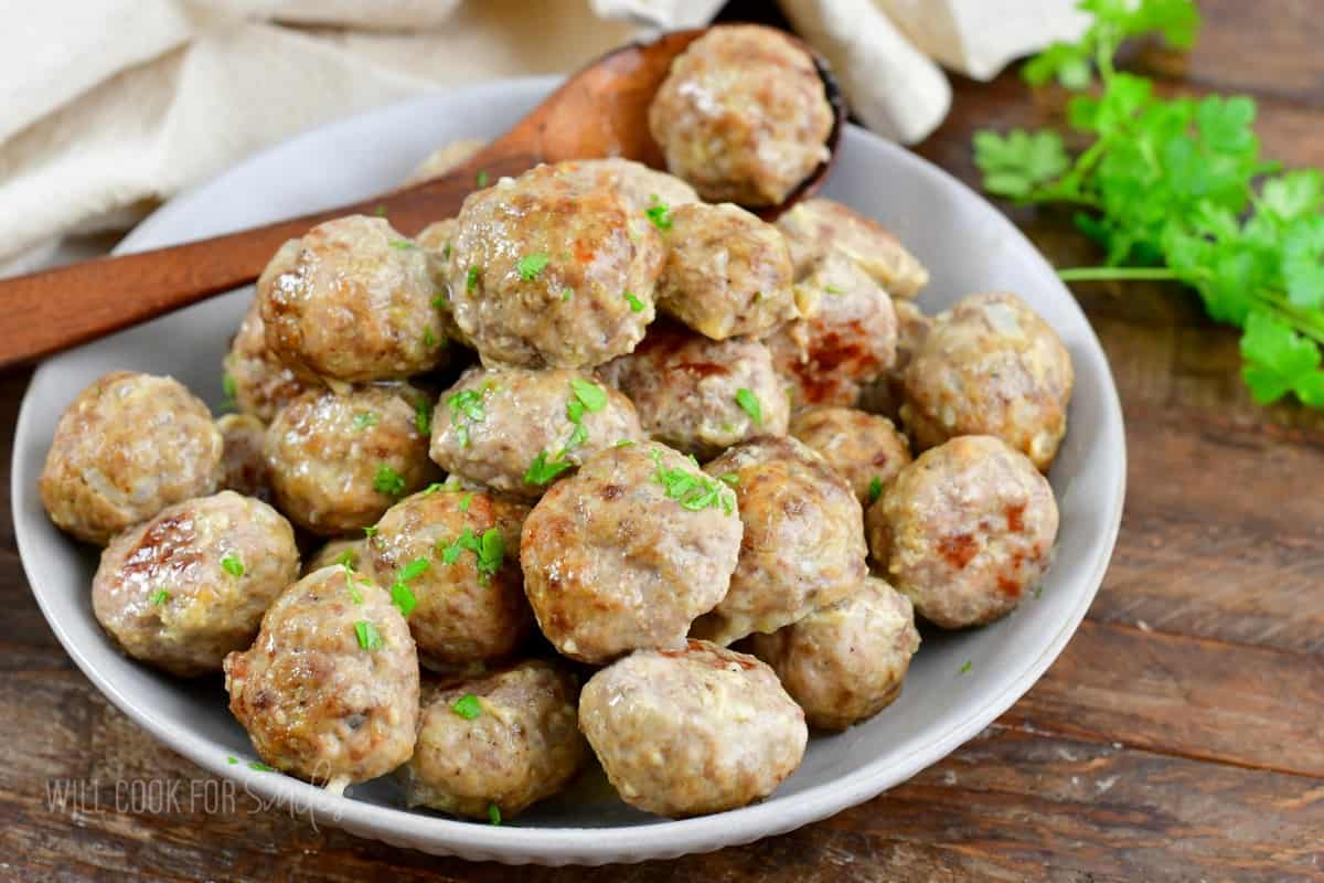 a bowl full of baked meatless and a spoon holding gone.