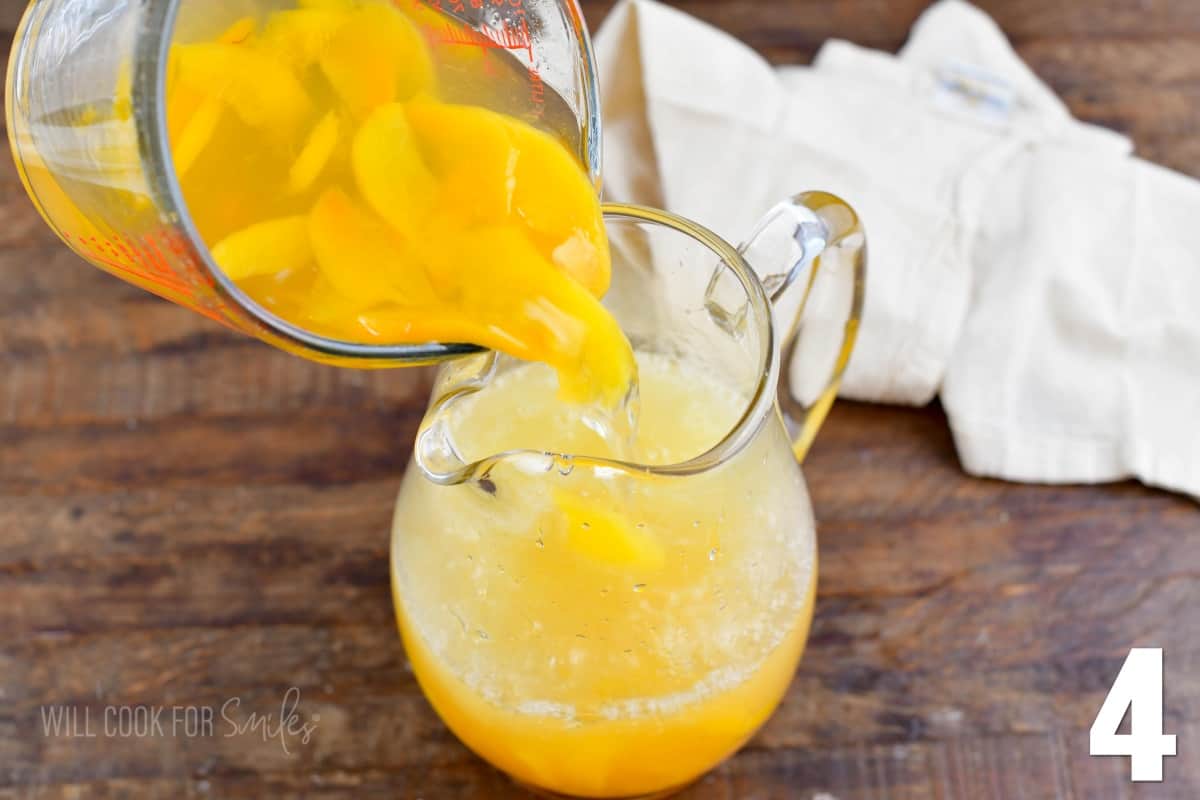 pouring cooked peaches and syrup into the glass jar with water and lemon juice.