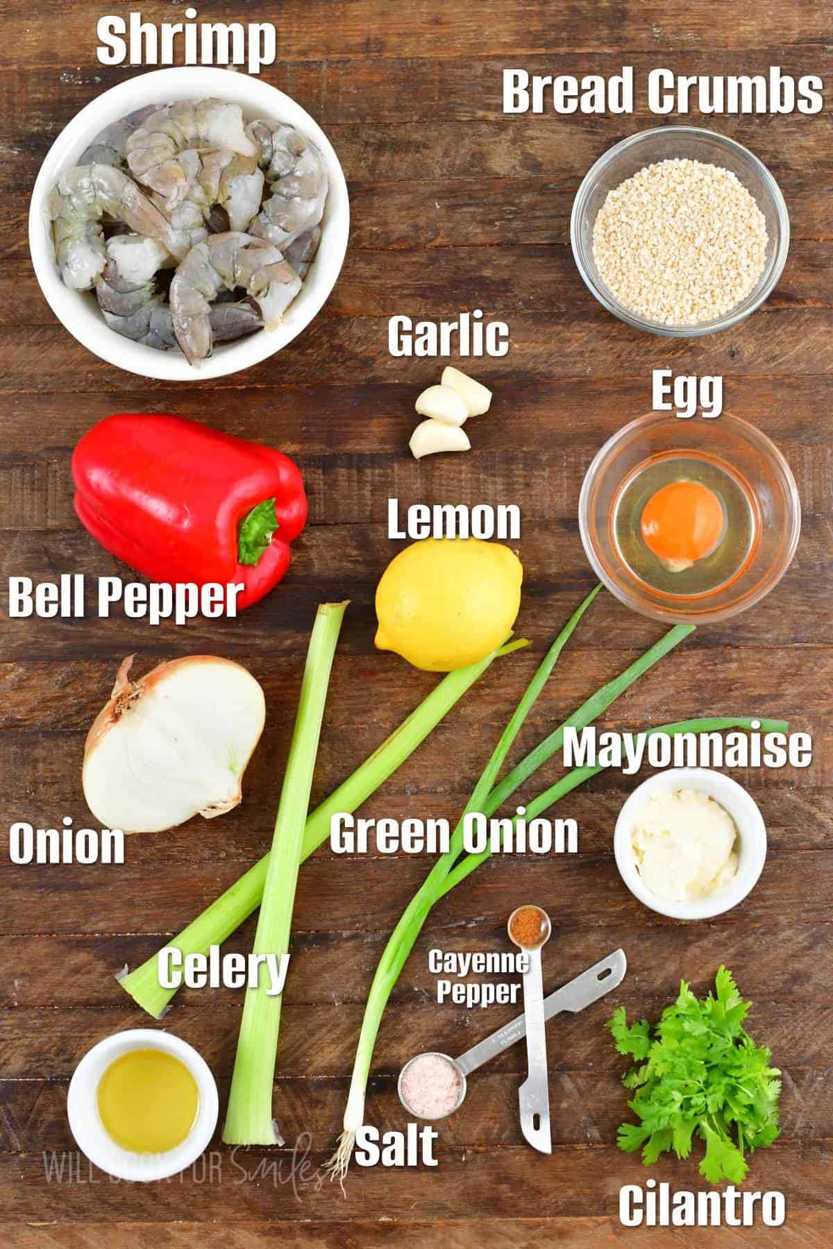 labeled ingredients to make shrimp burgers on a wooden background.