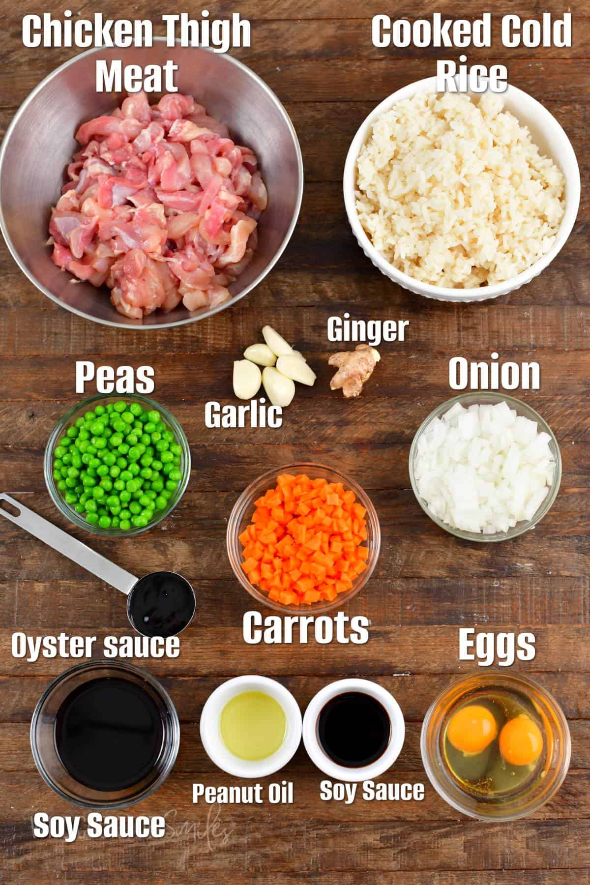 labeled ingredients to make chicken fried rice on the wooden board. 