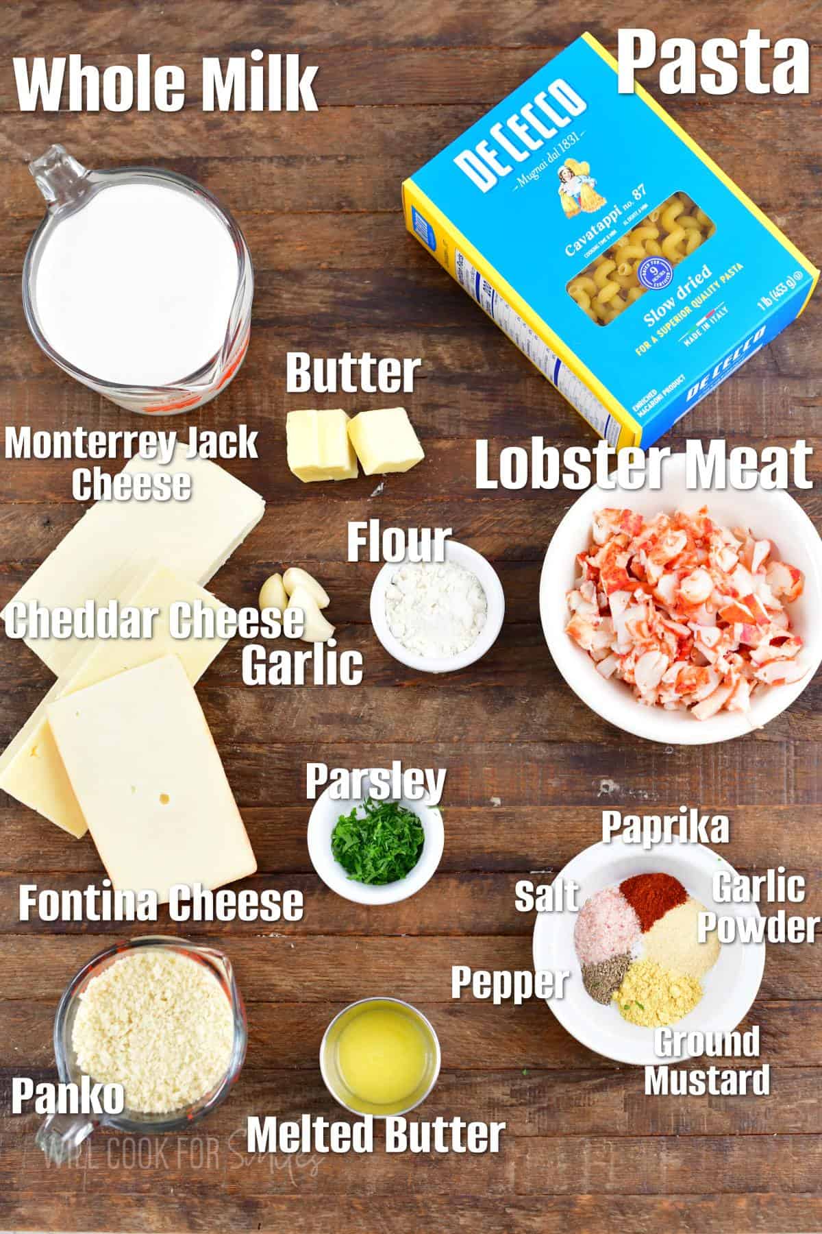 labeled ingredients to make lobster mac and cheese on the wooden board.