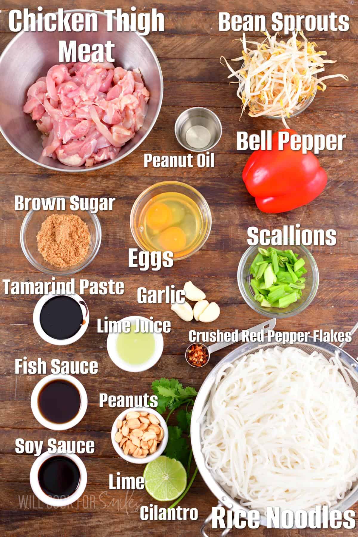 The ingredients for pad Thai are placed on a wooden surface. 