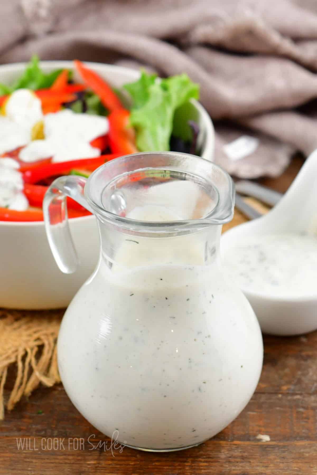 buttermilk ranch dressing next to a salad and a small bowl.