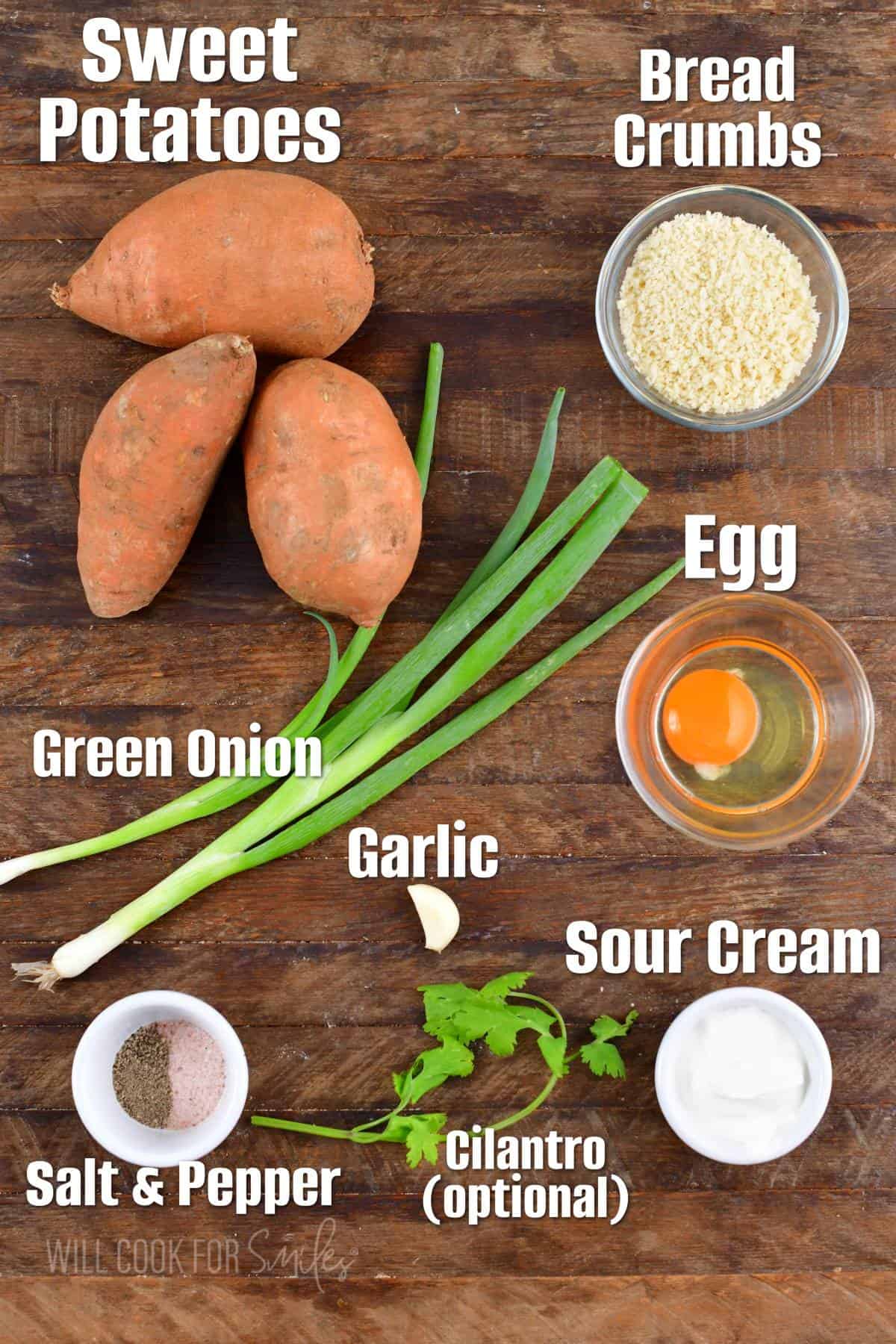 The ingredients for sweet potato cakes are placed on a wooden surface. 