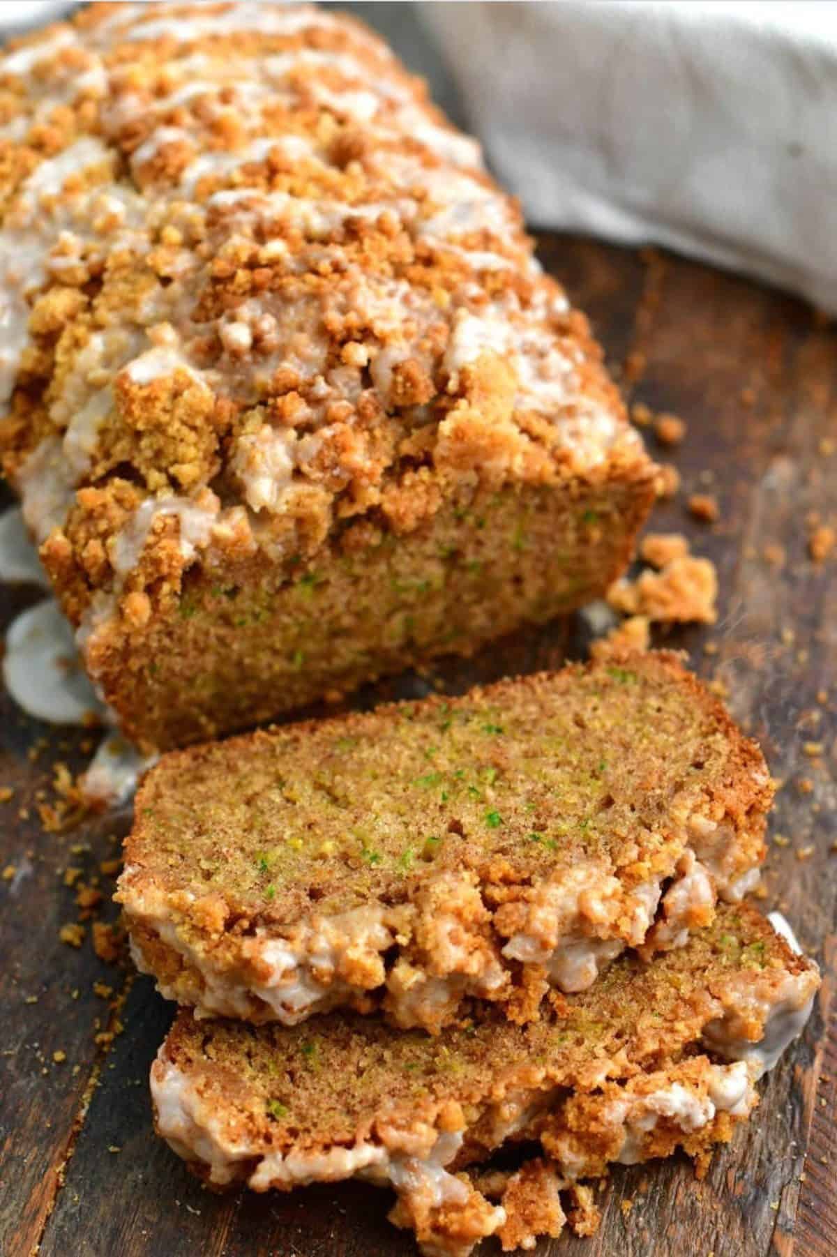 sliced zucchini bread pieces and loaf on the wooden board.