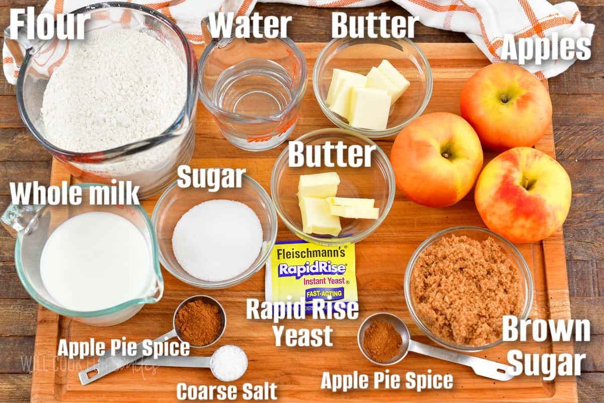 labeled ingredients to make apple pie monkey bread on the cutting board.