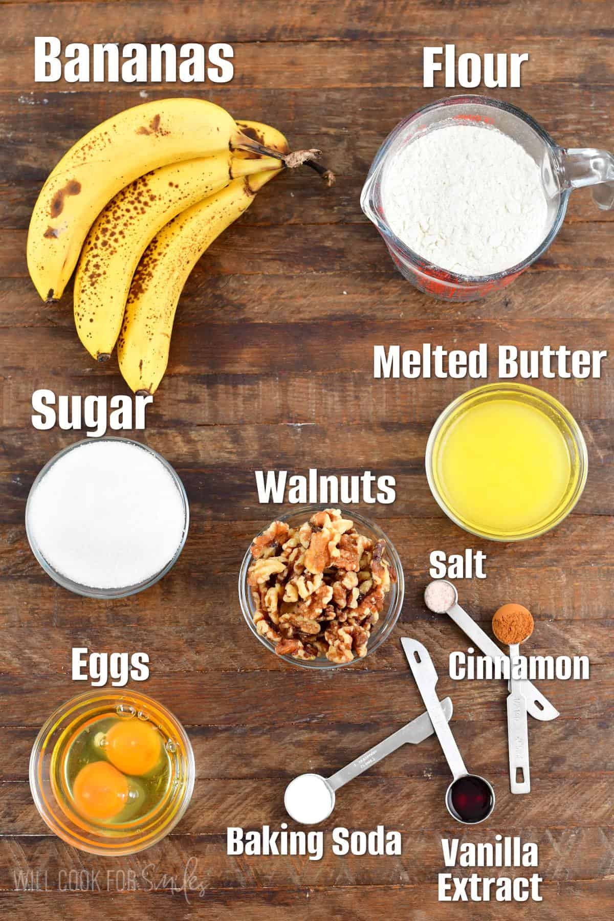The ingredients for banana bread are spread out on a wooden surface. 